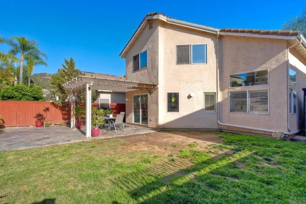 a view of a house with a yard and porch