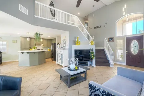 a living room with furniture and kitchen view