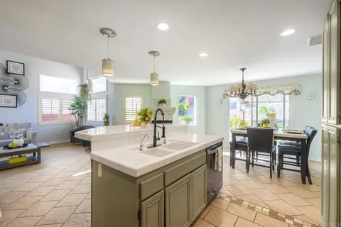 a kitchen with sink and chairs