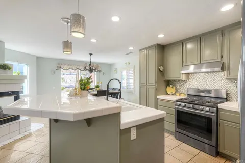 a kitchen with stainless steel appliances a sink stove and cabinets