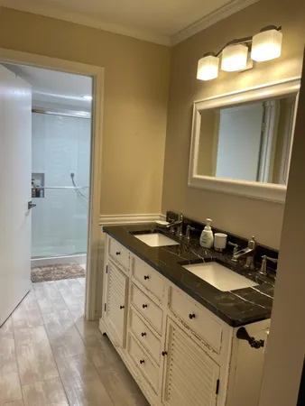 a bathroom with a double vanity sink and a mirror