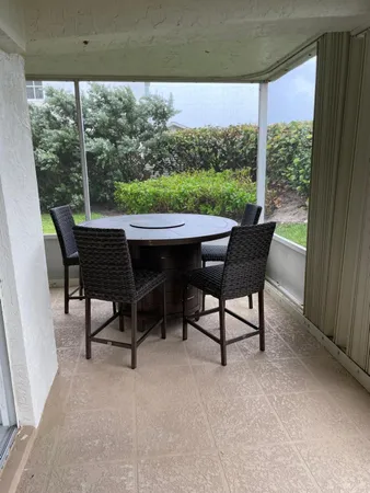 a view of a chairs and table in patio