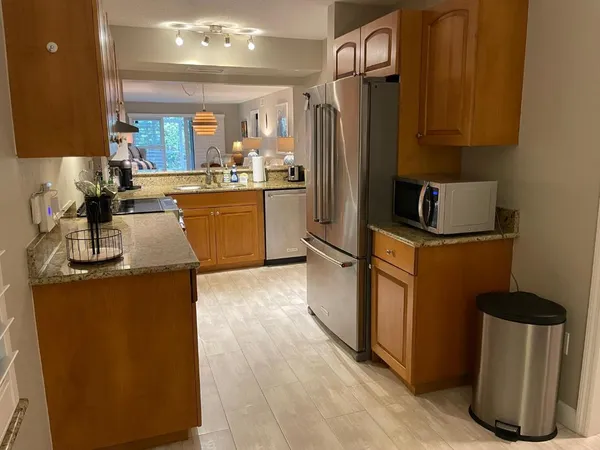 a kitchen with sink a refrigerator and cabinets