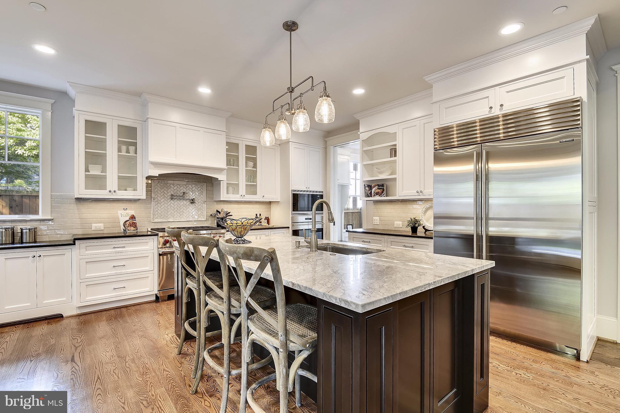 7810 Custer Road Bethesda, MD 20814 - Photo 6 of 30 a kitchen with counter space appliances and cabinets