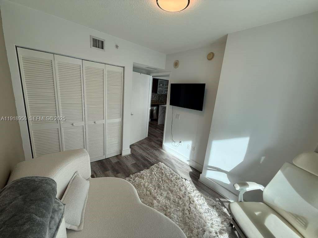 41 Southeast 5th Street, Unit 708 Miami, FL 33131 - Photo 11 of 29 a bedroom with a bed and a mirror