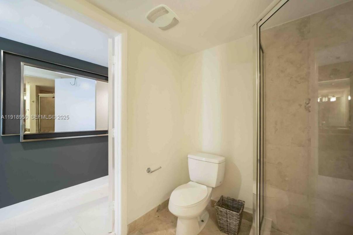 41 Southeast 5th Street, Unit 708 Miami, FL 33131 - Photo 12 of 29 a bathroom with a toilet sink and a mirror