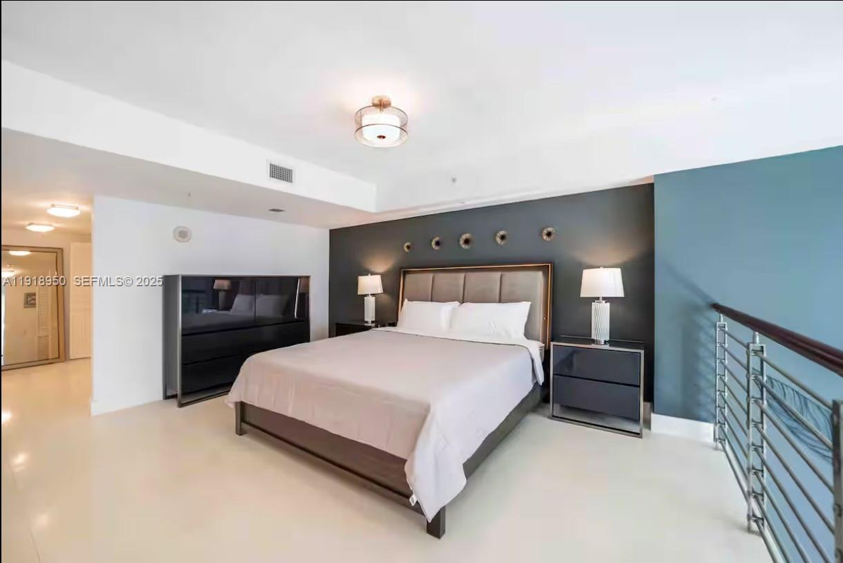 41 Southeast 5th Street, Unit 708 Miami, FL 33131 - Photo 13 of 29 a bedroom with a bed and a television