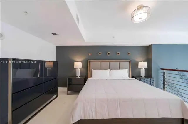 a spacious bedroom with a bed and a fireplace