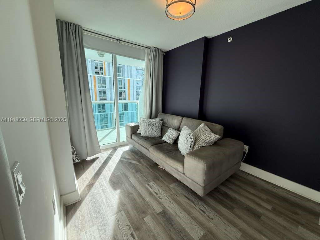 41 Southeast 5th Street, Unit 708 Miami, FL 33131 - Photo 17 of 29 a living room with furniture and a window