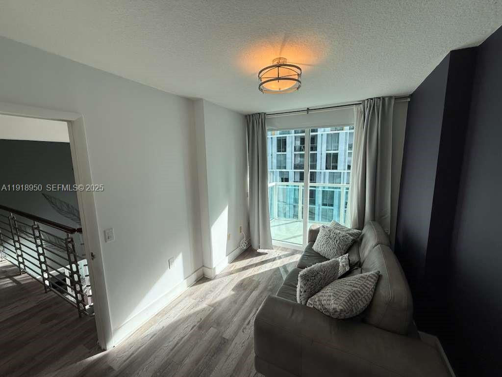41 Southeast 5th Street, Unit 708 Miami, FL 33131 - Photo 21 of 29 a living room with furniture and a large window