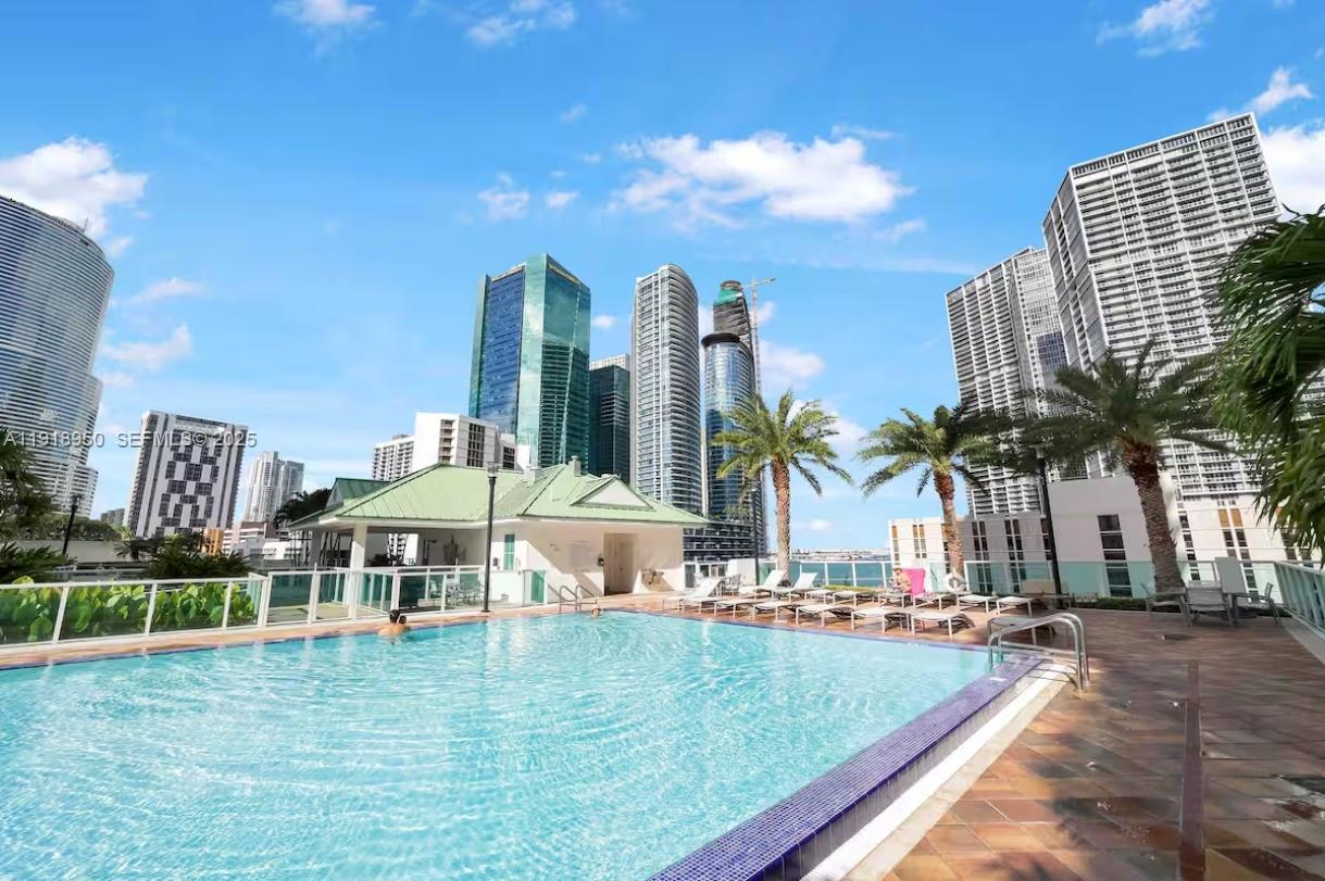41 Southeast 5th Street, Unit 708 Miami, FL 33131 - Photo 28 of 29 a view of a swimming pool with outdoor seating