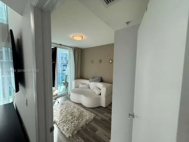 a bathroom with a sink and glass door