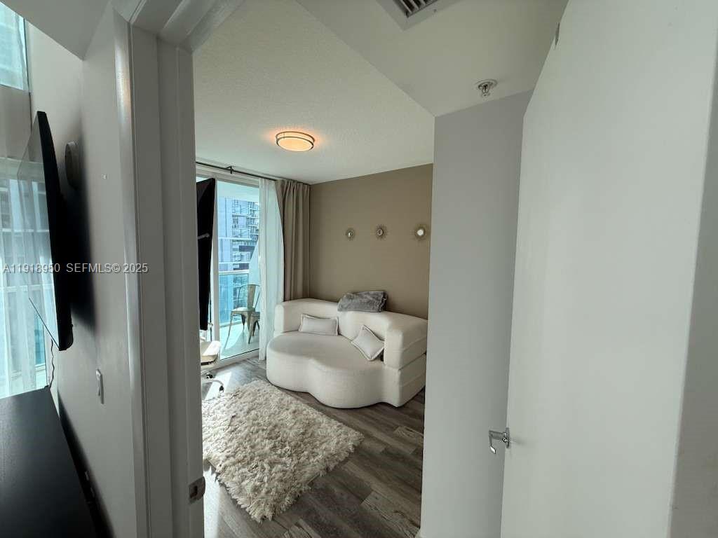 41 Southeast 5th Street, Unit 708 Miami, FL 33131 - Photo 6 of 29 a living room with furniture and a flat screen tv