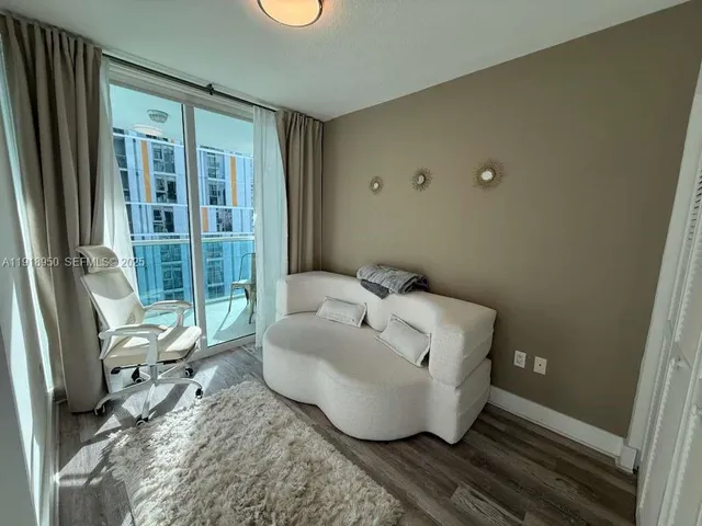 a bedroom with a bed and a rug