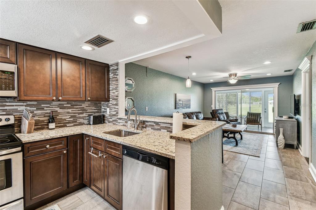 3745 Teeside Drive, Unit 3745 New Port Richey, FL 34655 - Photo 11 of 34 a kitchen with a sink a stove top cabinets and appliances