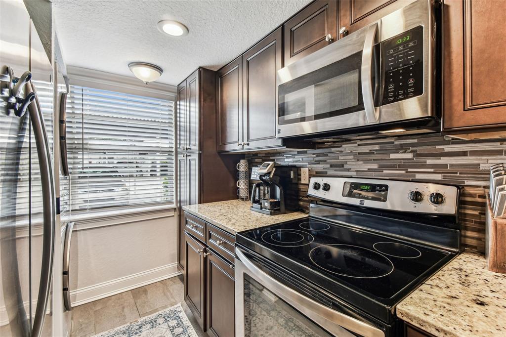 3745 Teeside Drive, Unit 3745 New Port Richey, FL 34655 - Photo 12 of 34 a stove top oven sitting inside of a kitchen