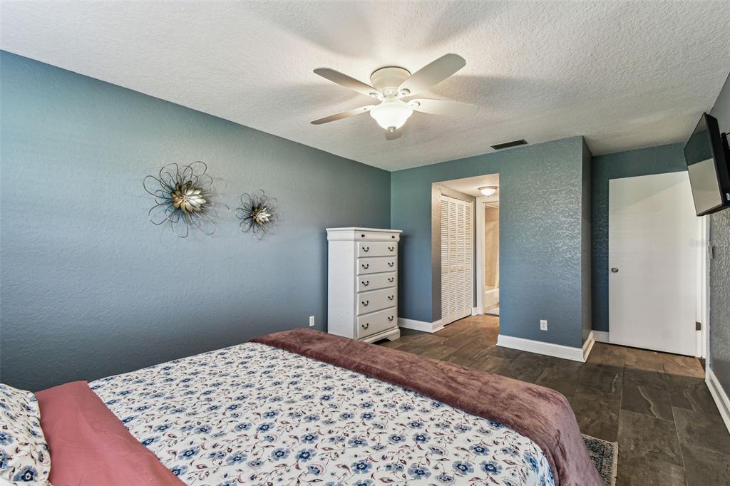 3745 Teeside Drive, Unit 3745 New Port Richey, FL 34655 - Photo 14 of 34 a bedroom with a large bed and a chandelier