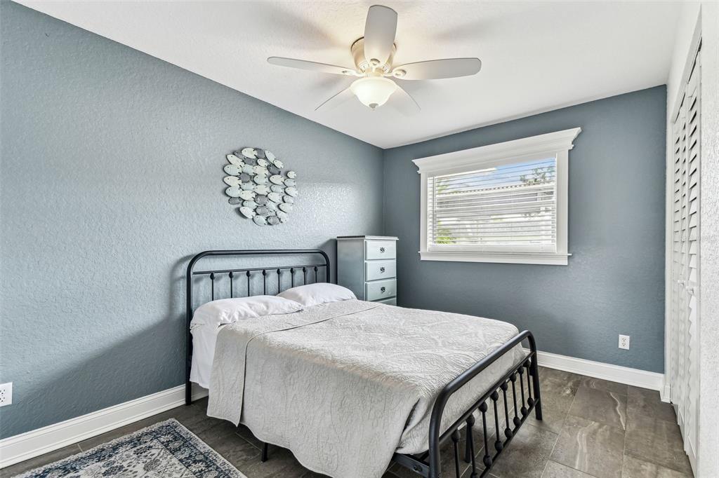 3745 Teeside Drive, Unit 3745 New Port Richey, FL 34655 - Photo 18 of 34 a bedroom with a bed and a chandelier