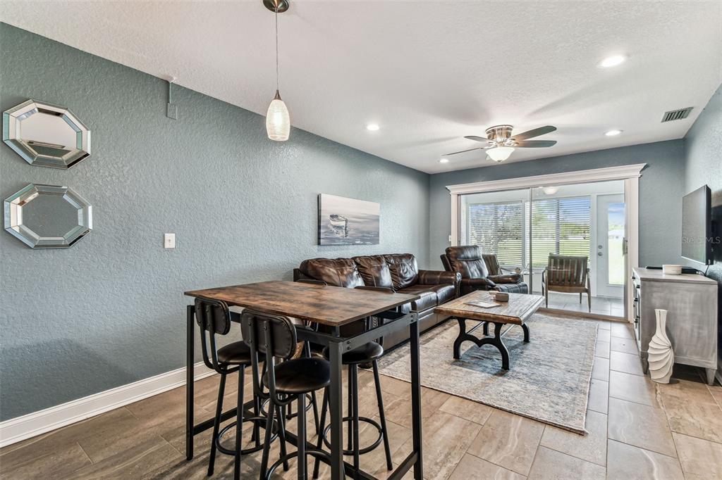 3745 Teeside Drive, Unit 3745 New Port Richey, FL 34655 - Photo 3 of 34 a view of a dining room with furniture window and wooden floor