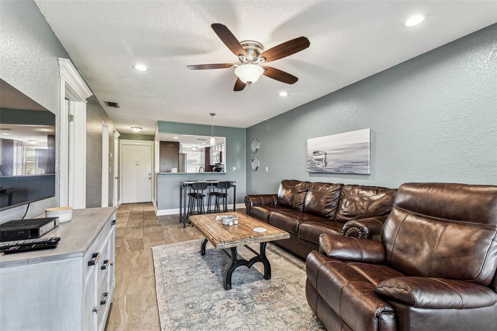 3745 Teeside Drive, Unit 3745 New Port Richey, FL 34655 - Photo 9 of 34 a living room with furniture and kitchen view
