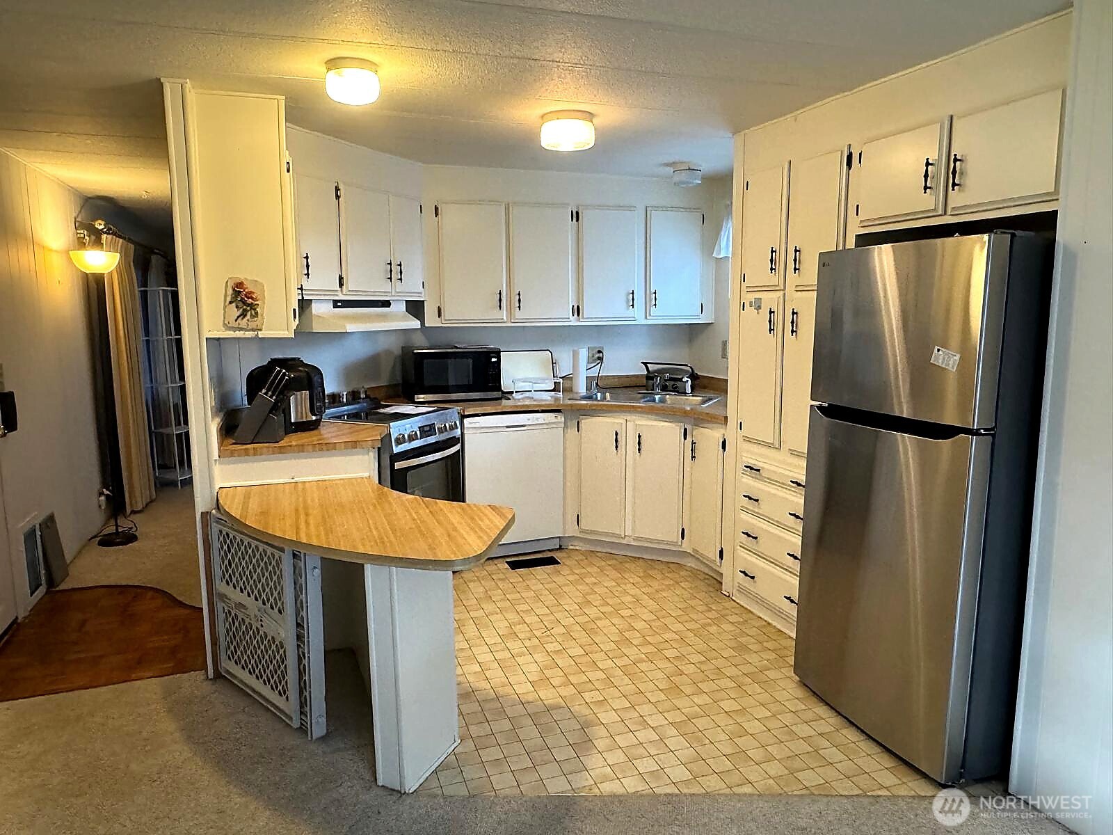 2210 Old Highway 99 South Road, Unit 31 Mount Vernon, WA 98273 - Photo 4 of 23 a kitchen with stainless steel appliances granite countertop a refrigerator a stove a sink and a refrigerator