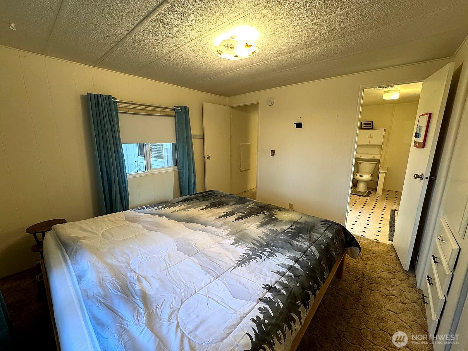 2210 Old Highway 99 South Road, Unit 31 Mount Vernon, WA 98273 - Photo 9 of 23 a bedroom with a bed and a mirror