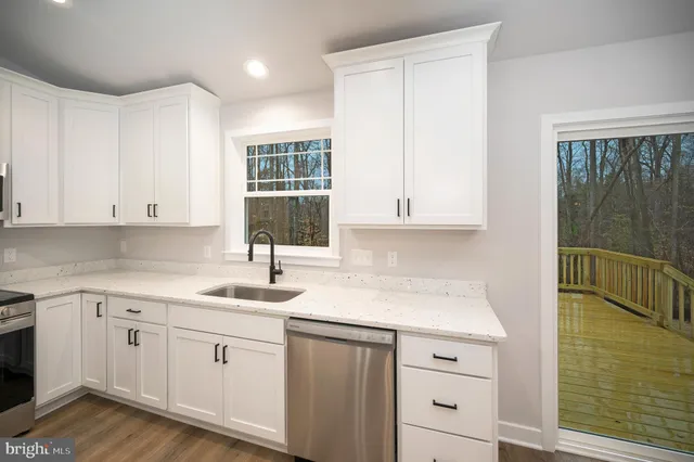 a kitchen with a sink cabinets and window