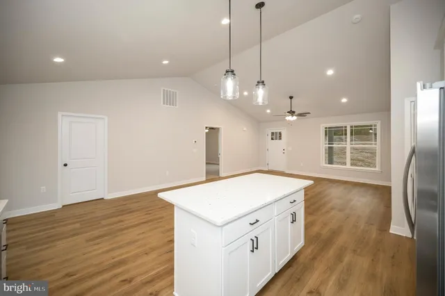 a kitchen with a stove and a wooden floor