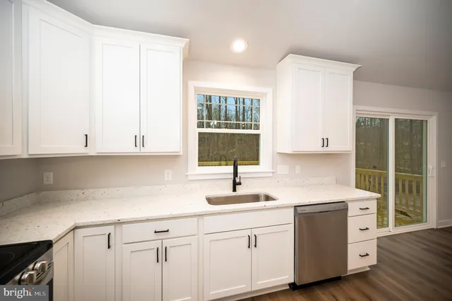 a kitchen with sink cabinets and window
