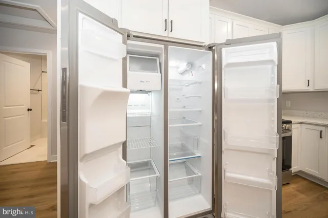 a bathroom with a glass shower door and a mirror