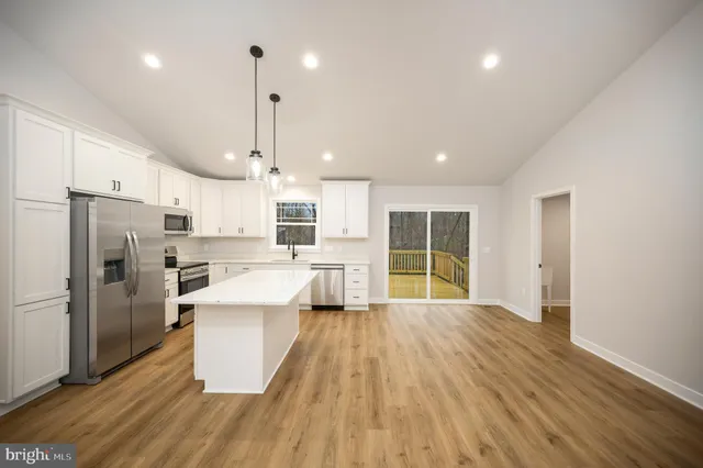 a kitchen with stainless steel appliances a refrigerator sink and cabinets