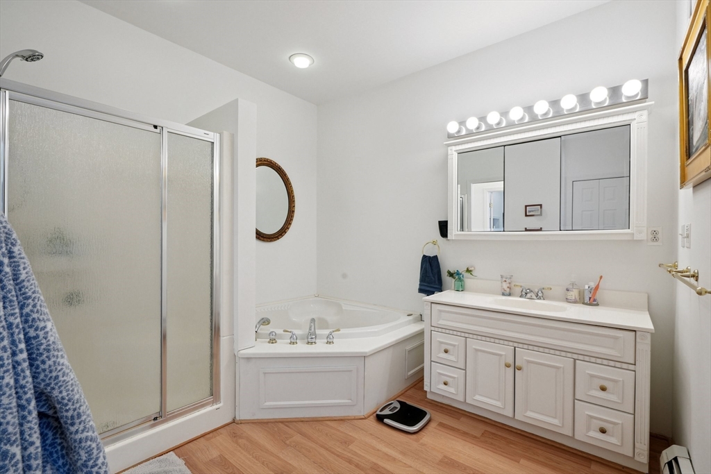 156 Langen Road Lancaster, MA 01523 - Photo 15 of 26 a bathroom with a tub sink double vanity and a mirror