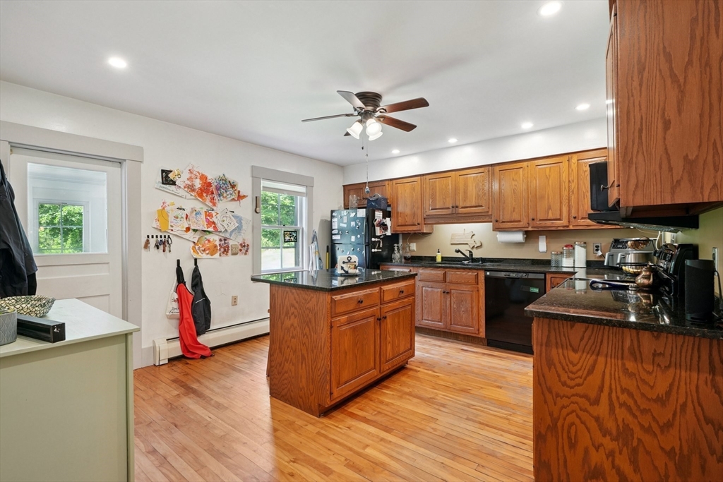 156 Langen Road Lancaster, MA 01523 - Photo 6 of 26 a kitchen with kitchen island granite countertop wooden floors stainless steel appliances and a sink