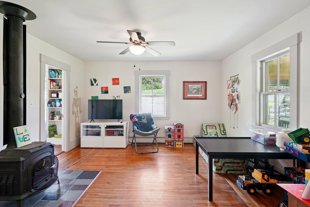 156 Langen Road Lancaster, MA 01523 - Photo 9 of 26 a living room with furniture wooden floor and a flat screen tv
