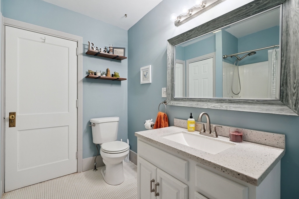 156 Langen Road Lancaster, MA 01523 - Photo 10 of 26 a bathroom with a sink a toilet and a mirror