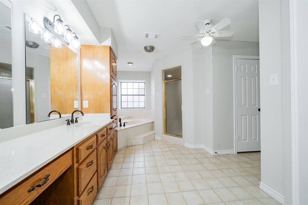 5612 Highway 243 Kaufman, TX 75142 - Photo 21 of 32 a spacious bathroom with a double vanity sink and a mirror