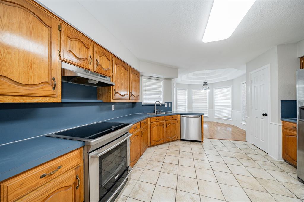 5612 Highway 243 Kaufman, TX 75142 - Photo 10 of 32 a kitchen with stainless steel appliances granite countertop a sink and cabinets