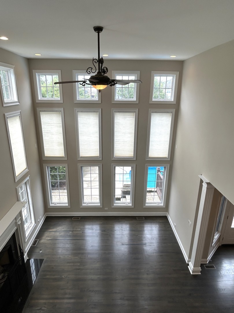 3932 Bluejay Lane Naperville, IL 60564 - Photo 21 of 50 a view of an empty room with wooden floor and a window