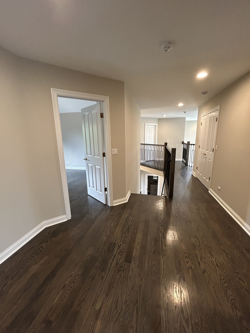3932 Bluejay Lane Naperville, IL 60564 - Photo 22 of 50 an empty room with wooden floor and fireplace