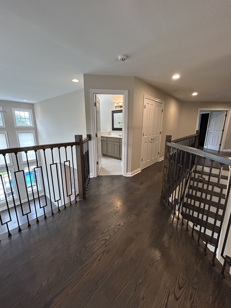 3932 Bluejay Lane Naperville, IL 60564 - Photo 23 of 50 a view of a hallway with wooden floor and windows