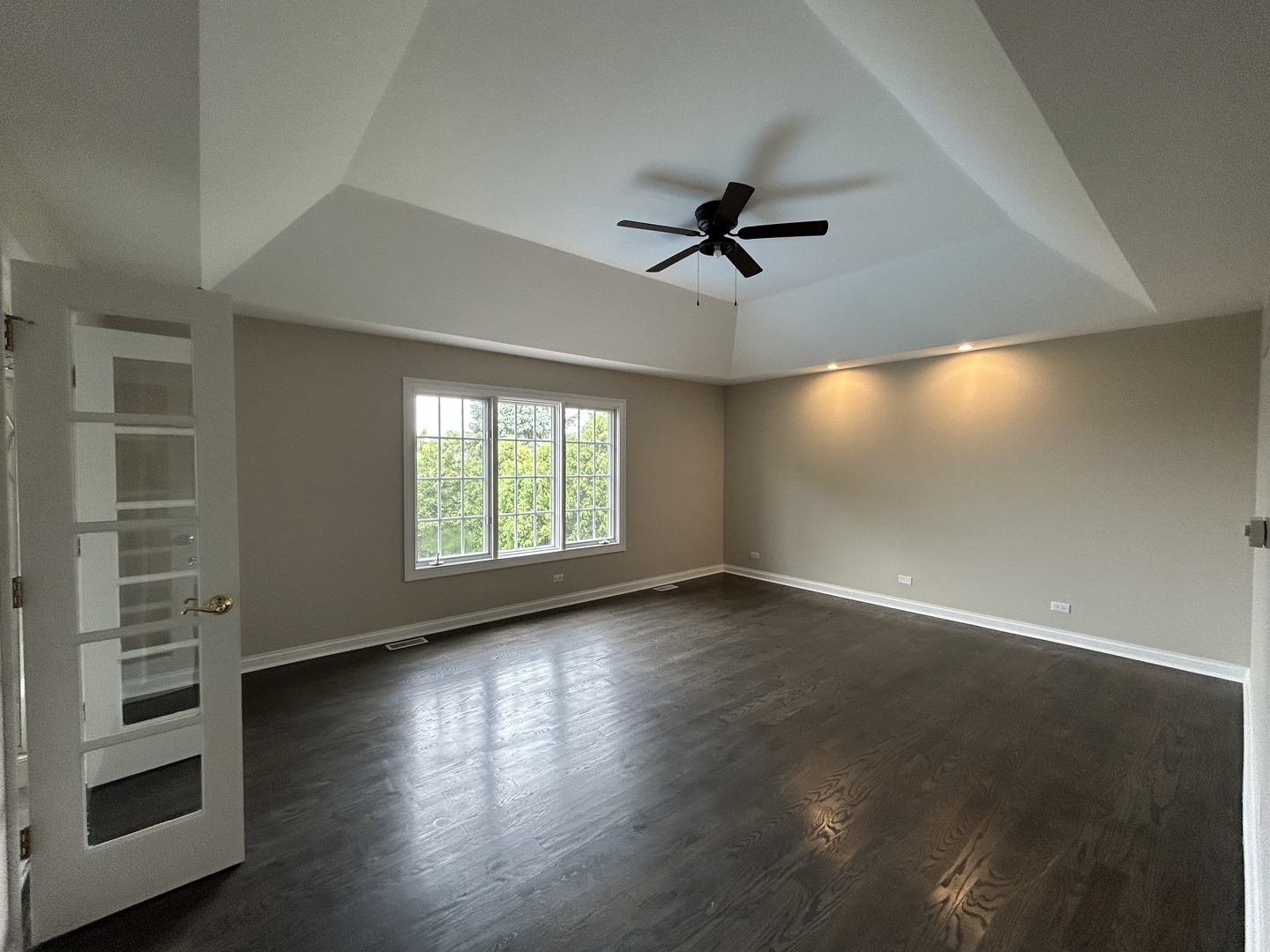 3932 Bluejay Lane Naperville, IL 60564 - Photo 24 of 50 a view of empty room with wooden floor and fan