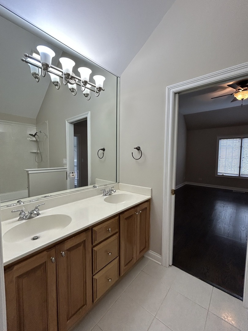 3932 Bluejay Lane Naperville, IL 60564 - Photo 35 of 50 a spacious bathroom with a double vanity sink and a mirror