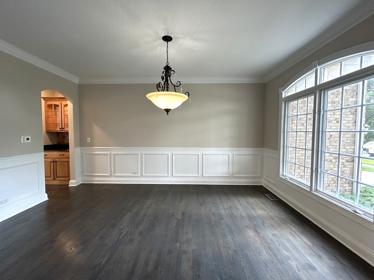3932 Bluejay Lane Naperville, IL 60564 - Photo 4 of 50 a view of an empty room with a window and wooden floor
