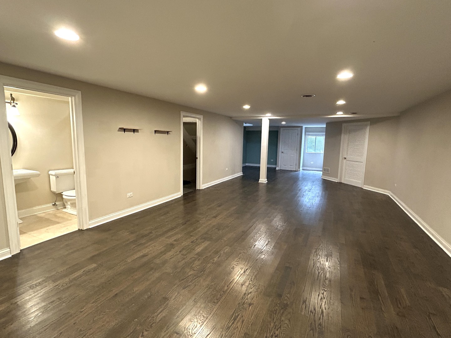 3932 Bluejay Lane Naperville, IL 60564 - Photo 42 of 50 a view of an empty room with wooden floor and a bathroom