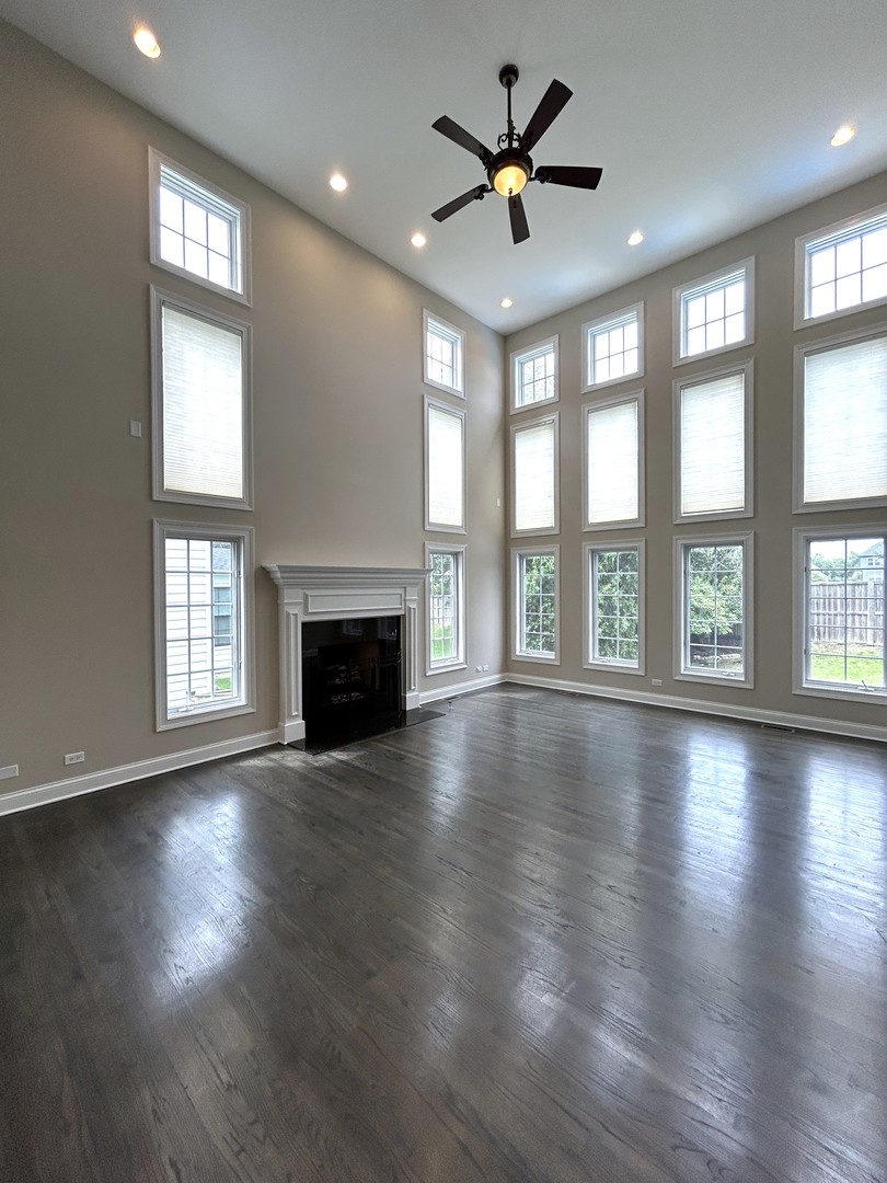 3932 Bluejay Lane Naperville, IL 60564 - Photo 7 of 50 an empty room with wooden floor and windows