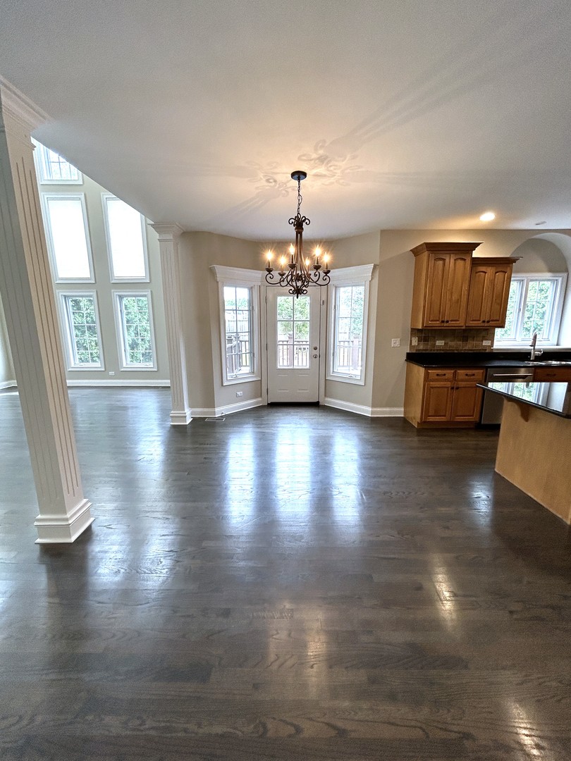 3932 Bluejay Lane Naperville, IL 60564 - Photo 10 of 50 a view of a livingroom with furniture wooden floor a chandelier and windows