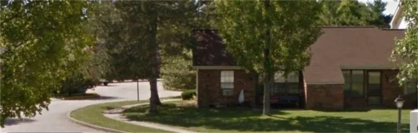 a view of a house with a backyard