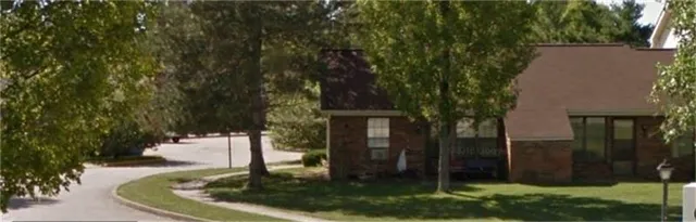 a view of a house with a backyard
