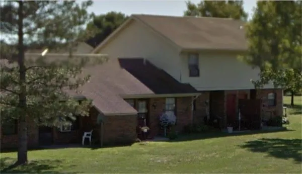 a view of a house with a yard