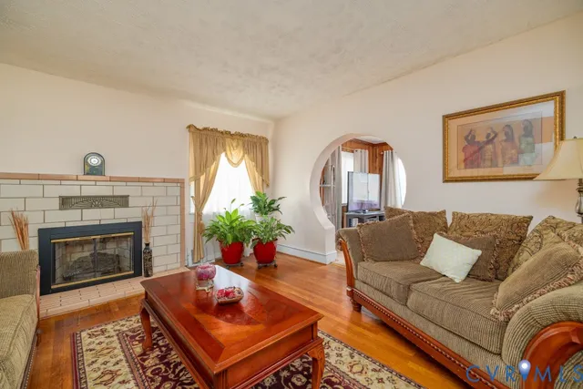 a living room with furniture and a fireplace